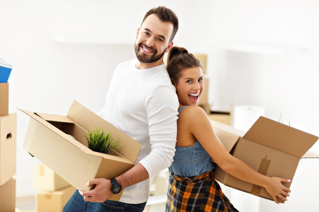 couple smiling for moving out cleanup