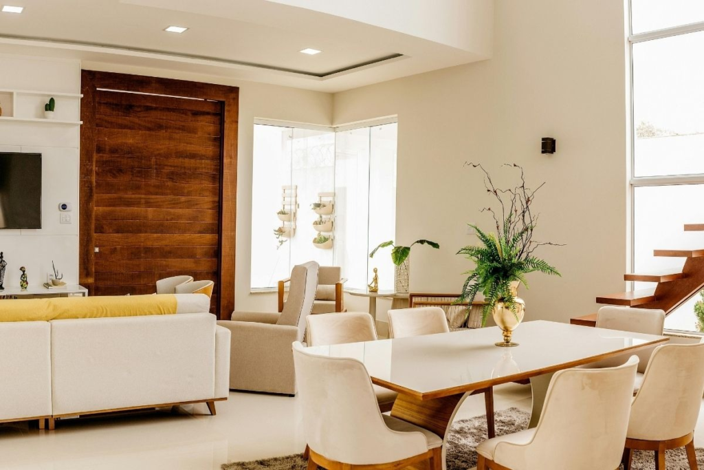 Modern living room with a white sofa and wood door on flat surfaces.